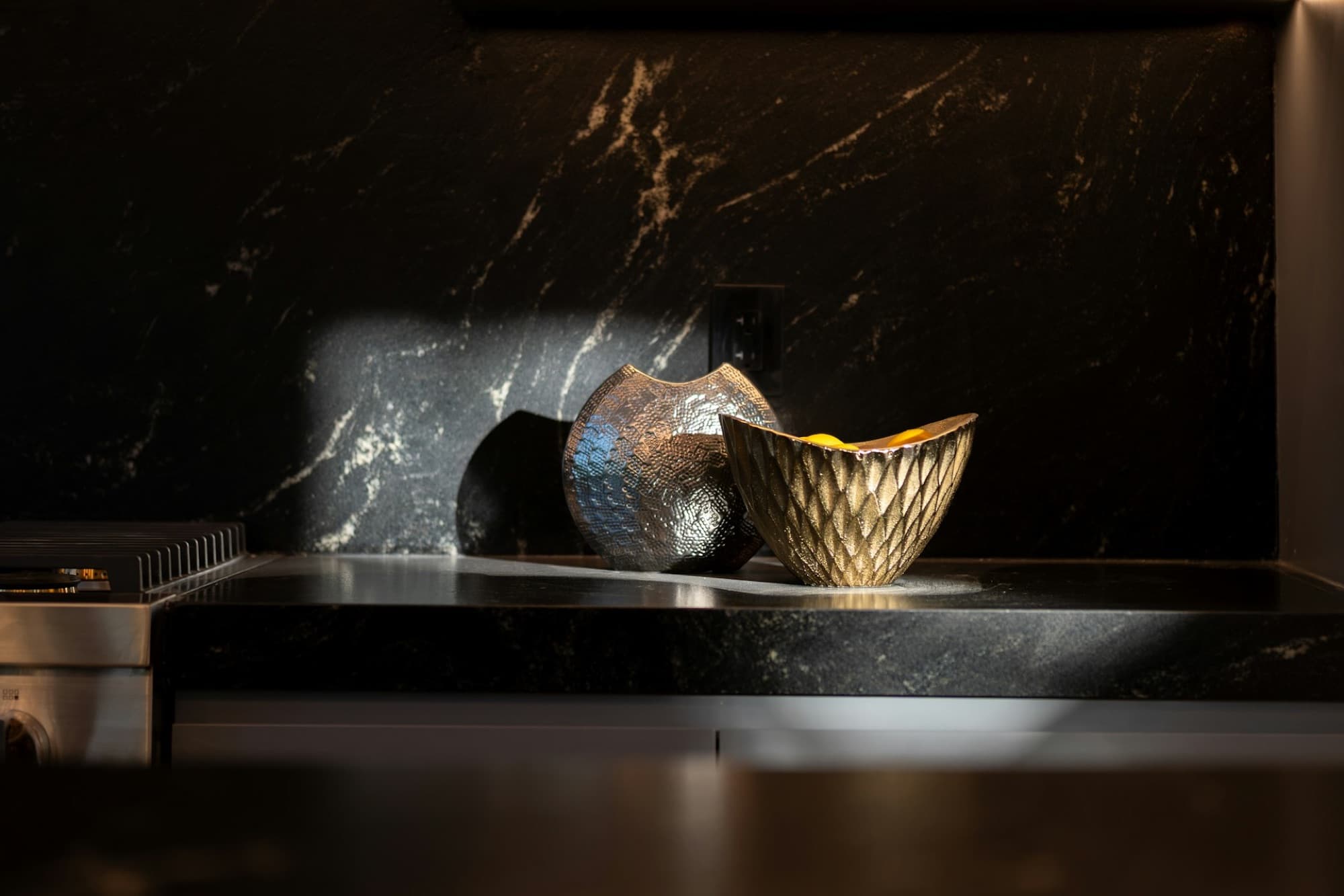 Hammered metal bowls on a Nero Marquina marble counter